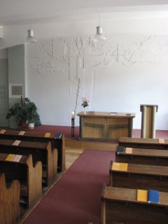 Interiér modlitebny s plastikou stromu-kříže